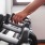 a person reaching for some dumbbells at resident fitness center at Rivermark Northern Liberties apartments
