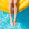 A person floating in resort-style resident pool at Rivermark Northern Liberties apartments