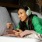 A woman with headphones laying on bed