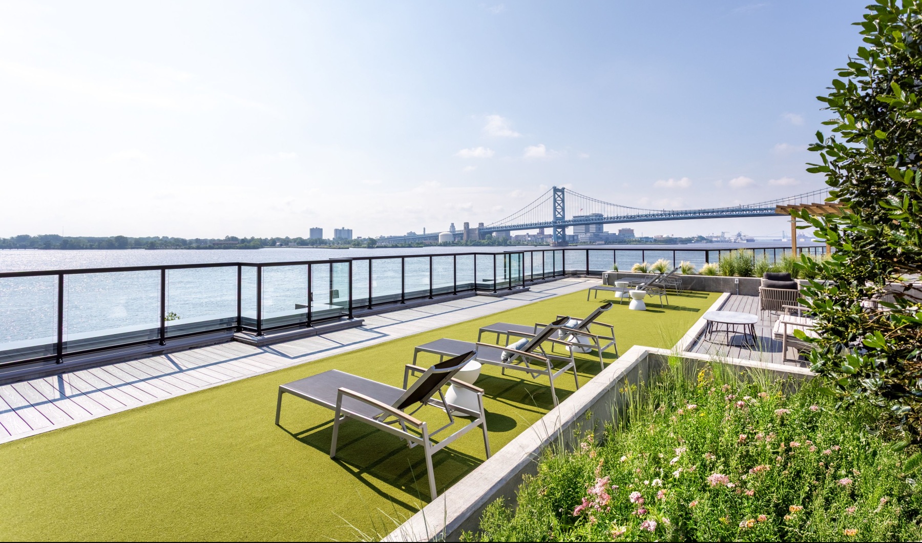 courtyard sundeck with lounge chairs overlooking the water  Rivermark Northern Liberties Philadelphia PA luxury apartments